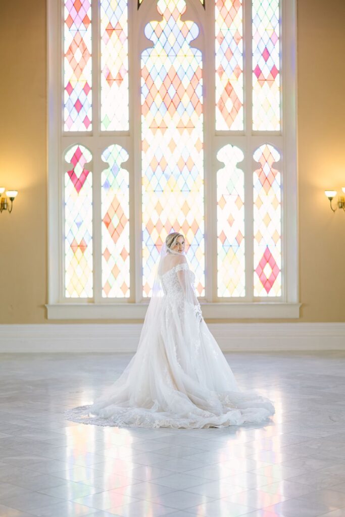 Satin ball gown wedding dress in a ballroom