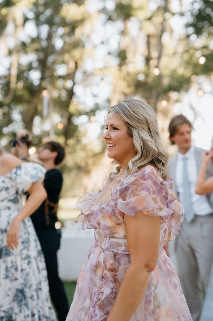 Half-up half-down wedding guest hairstyle with soft waves