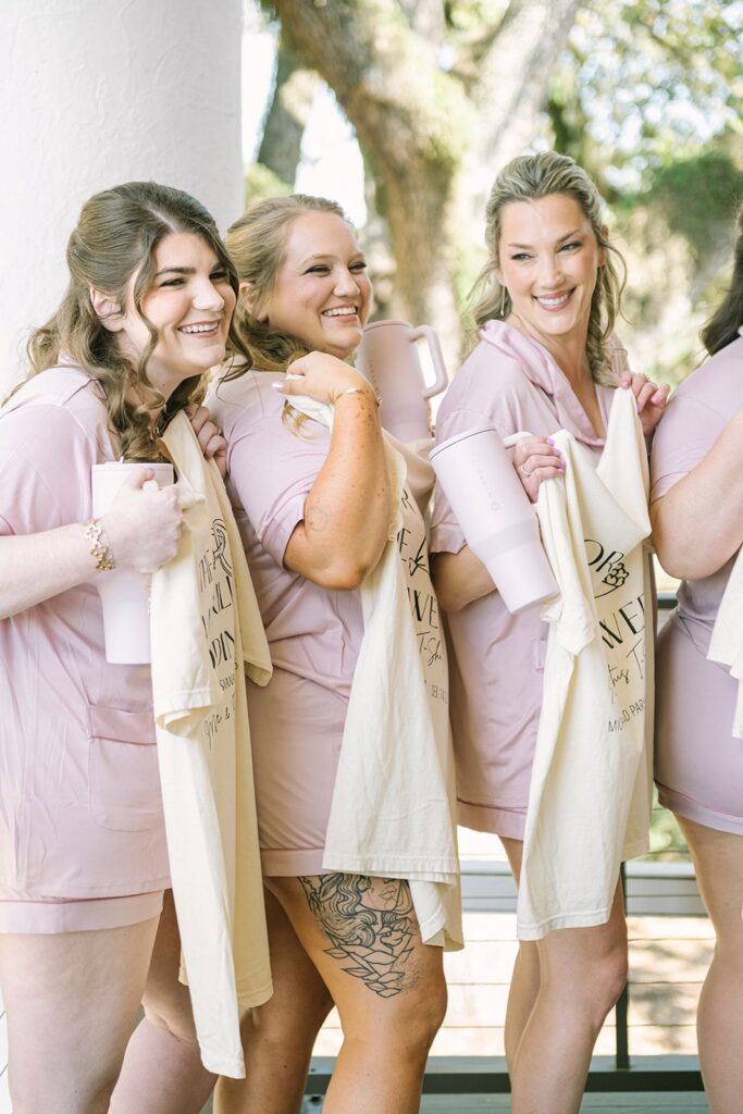 Loose romantic wedding guest updo with soft curls and delicate texture