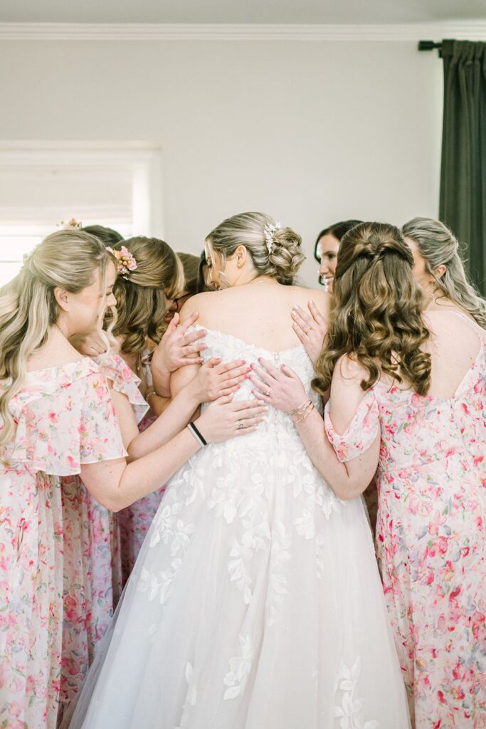 Soft romantic bun wedding guest hairstyle with loose face-framing curls